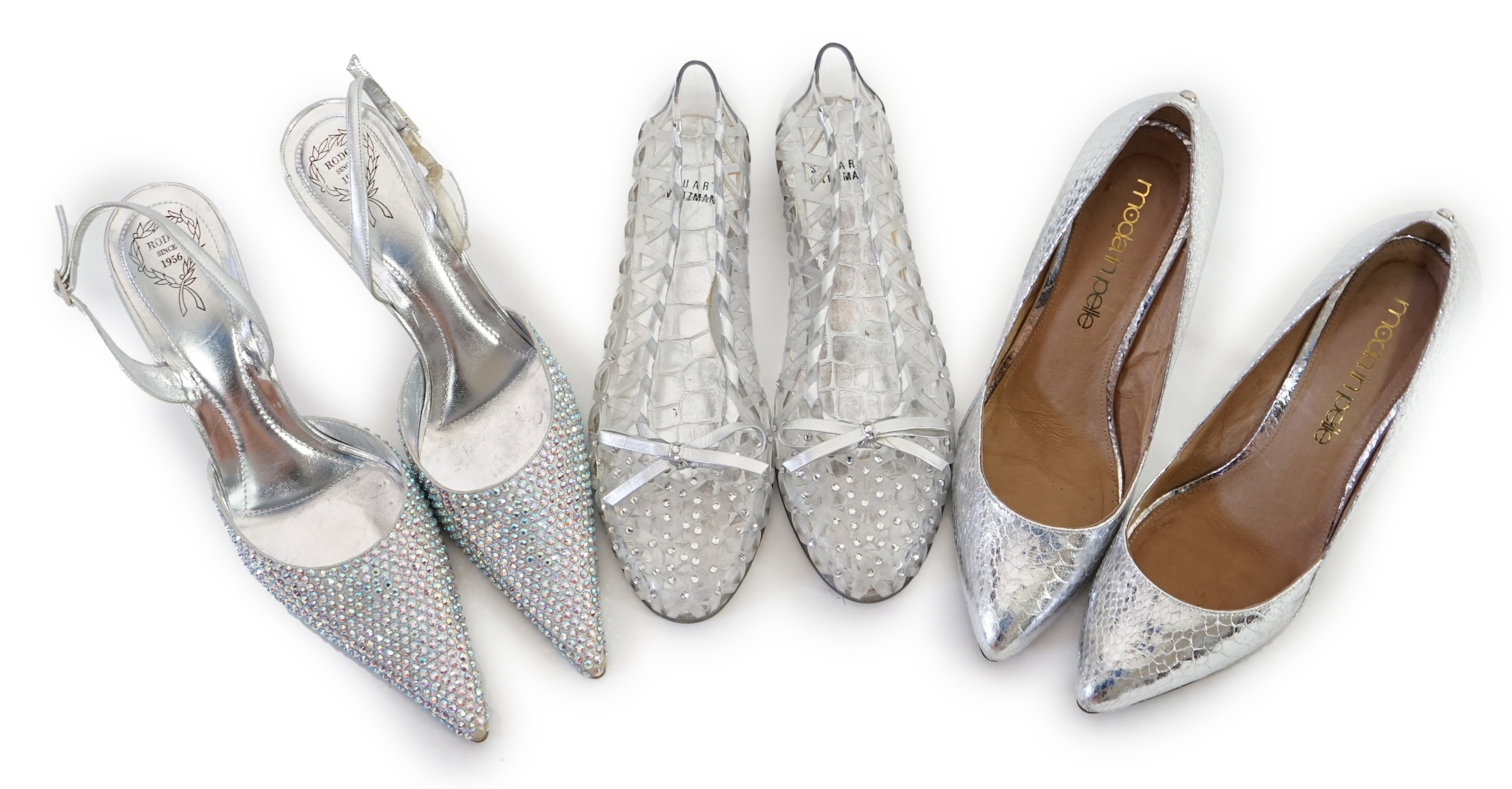 Three pairs of lady's silver shoes: Rodo silver diamonté sling back heels, Moda in Pelle silver snakeskin pattern heeled pumps and a pair of Stuart Weitzman clear jelly's with crystals. Size 38.5 (UK 4). Proceeds to Happ
